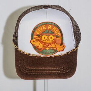 Brown and white "Give a Hoot" trucker hat with gold hat jewelry